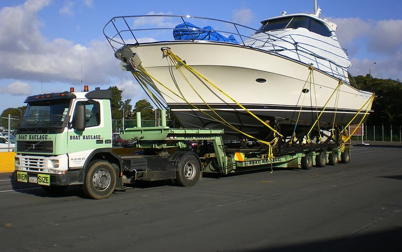 large yacht on back of trailer prepared for shipping