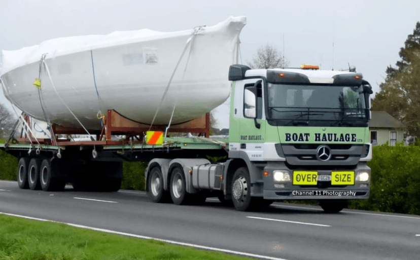 boat haulage transporting a shrink wrapped heavy boat