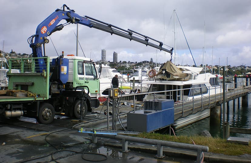boat haulage crane truck HIAB lifting boat at marina