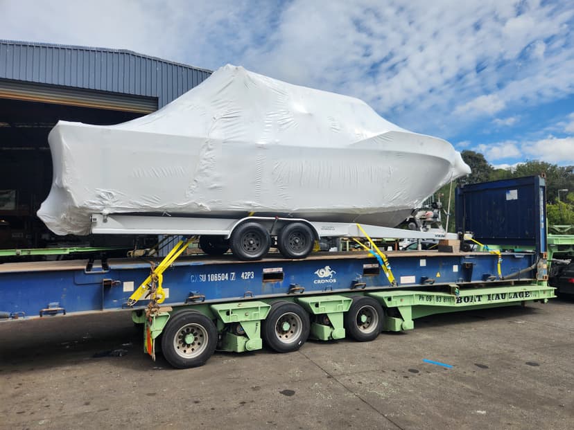 boat haulage with shrink wrapped boat on truck